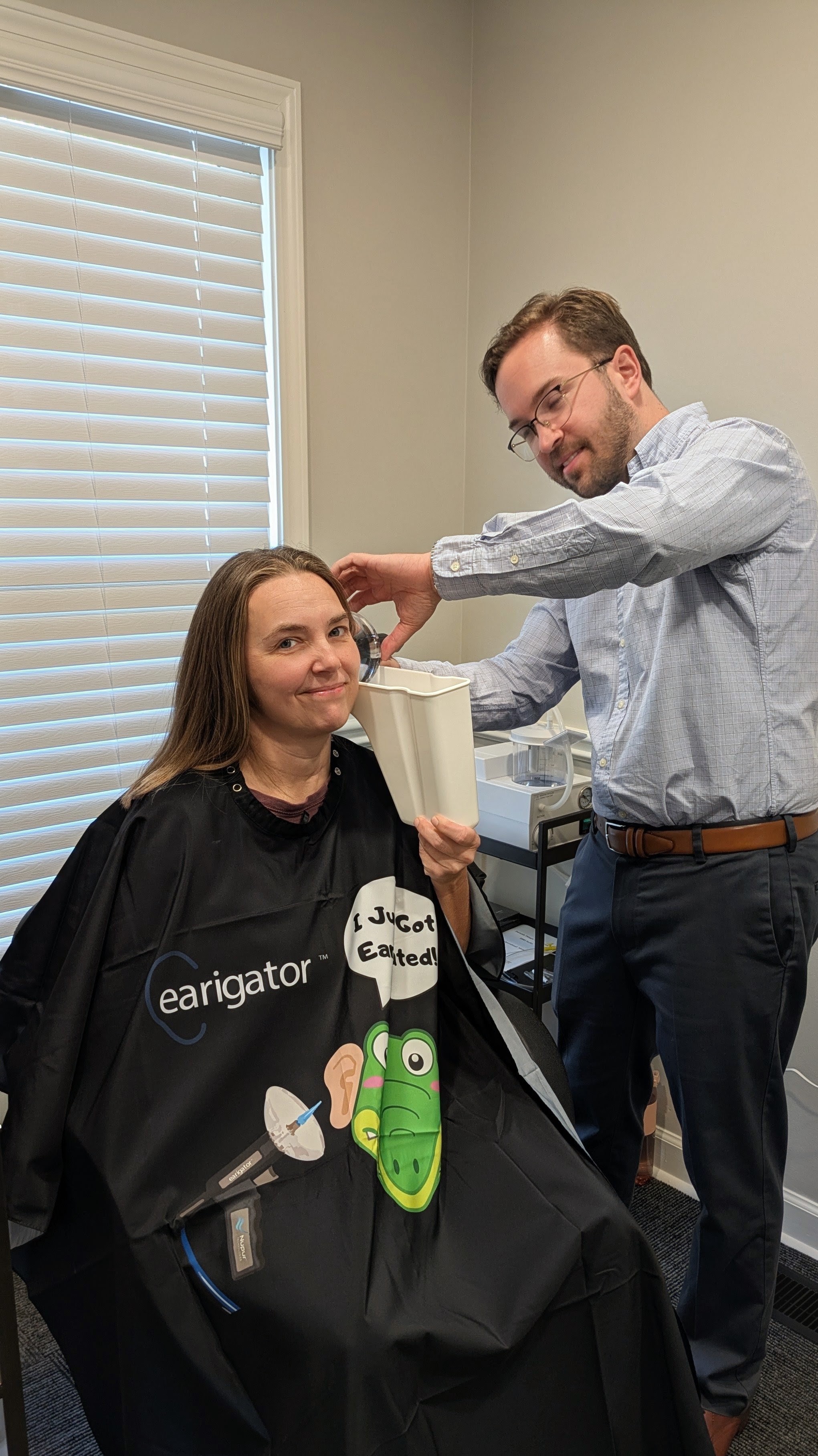 Doctor of Audiology performing professional earwax removal