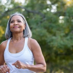 Woman jogging in public park.