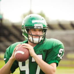 Football player holding ball during game