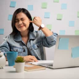 Woman plugging her ear trying to drown out tinnitus