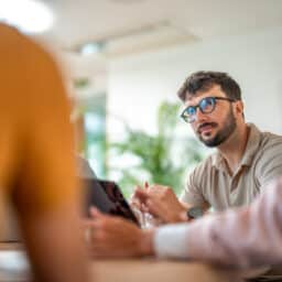 Man listens in a meeting